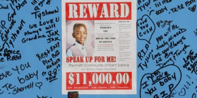 A reward sign and messages hang in November 2015, near where Tyshawn Lee was fatally shot in Chicago.