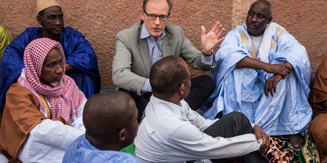 In this Nov. 3, 2017, photo provided by the United Nations, Andrew Gilmour, center, assistant secretary-general for human rights, meets with Peul religious leaders from Mopti to discuss human rights issues and the security situation in the region in Mali. (Harandane Dicko/United Nations via AP)