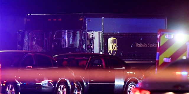 In this Thursday, Dec. 5, 2019, photo authorities investigate the scene of a shooting in Miramar, Fla. The FBI says several people, including a UPS driver, were killed after robbers stole the driver’s truck and led police on a chase that ended in gunfire at a busy South Florida intersection during rush hour. (Taimy Alvarez/South Florida Sun-Sentinel via AP)