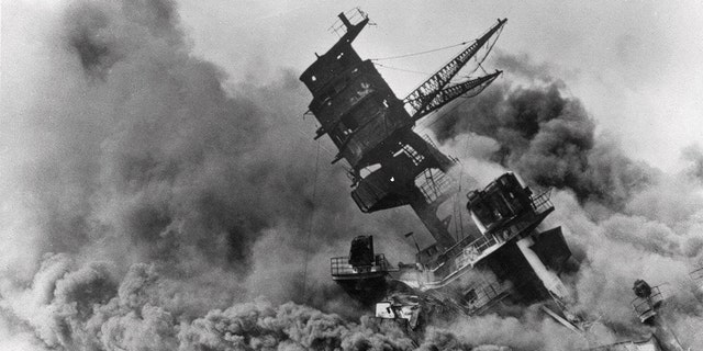 FILE - In this Dec. 7, 1941, file photo, smoke rises from the battleship USS Arizona as it sinks during the Japanese attack on Pearl Harbor, Hawaii. (AP Photo, File)