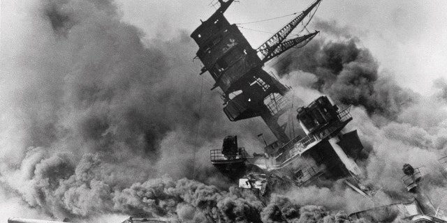 FILE - In this Dec. 7, 1941, file photo, smoke rises from the battleship USS Arizona as it sinks during the Japanese attack on Pearl Harbor, Hawaii. (AP Photo, File)
