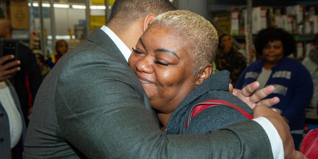 Suwanda McCreary hugs Cascade United Methodist Church senior pastor, Kevin Murriel, after his church paid for $10,000 worth of items in layaway at an Atlanta-area Walmart. McCreary's 28-year-old son died in April and he left three kids behind. She said it meant a lot to her.