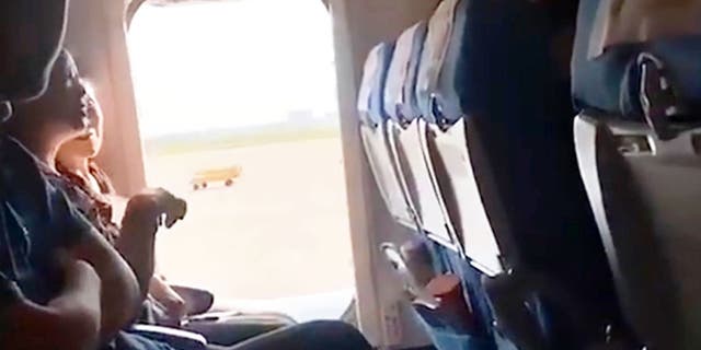 The woman opened the emergency exit door of the aircraft because she reportedly felt the cabin was “too stuffy” and wanted “a breath of fresh air.” (AsiaWire)