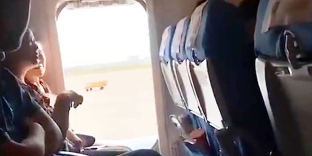 The woman opened the emergency exit door of the aircraft because she reportedly felt the cabin was “too stuffy” and wanted “a breath of fresh air.” (AsiaWire)