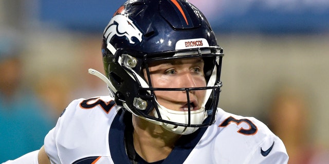 In this Aug. 1, 2019, file photo, Denver Broncos quarterback Drew Lock scrambles during the second half of the Pro Football Hall of Fame NFL preseason game against the Atlanta Falcons in Canton, Ohio. The Broncos are increasing rookie quarterback Drew Lock’s workload at practice this week to determine if he should get his first NFL start against the Chargers this weekend. (AP Photo/David Richard, File)