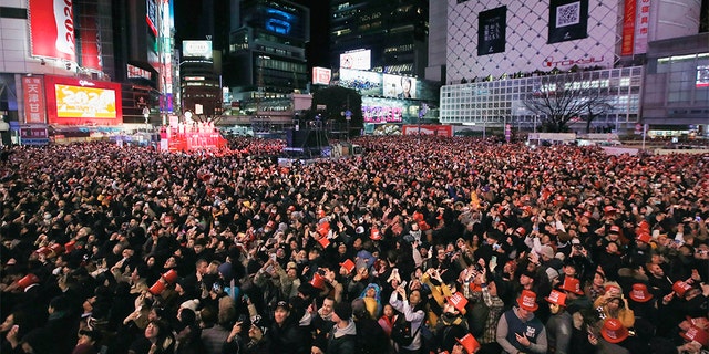 People gather to welcome the arrival of the New Year at a crossing in Shibuya district in Tokyo Wednesday, Jan. 1, 2020. (Associated Press)