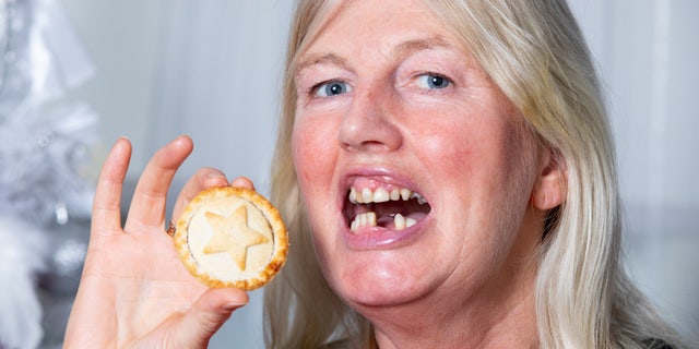Angela McGill lost two of her front teeth when eating a mince pie.