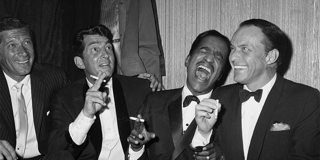 Jan Murray (L) sits alongside Rat Pack members Dean Martin, Sammy Davis Jr., and Frank Sinatra as the group unwinds backstage at Carnegie Hall after entertaining at a benefit performance in honor of Dr. Martin Luther King Jr.