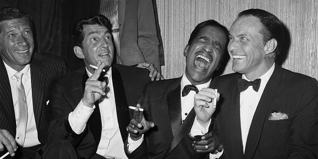 Jan Murray (L) sits alongside Rat Pack members Dean Martin, Sammy Davis Jr., and Frank Sinatra as the group unwinds backstage at Carnegie Hall after entertaining at a benefit performance in honor of Dr. Martin Luther King Jr.