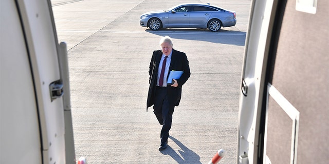 Britain's Prime Minister and Conservative Party leader Boris Johnson boards a plane at Doncaster Sheffield Airport in Doncaster, England, on Monday, during campaigning ahead of the general election on Dec. 12.