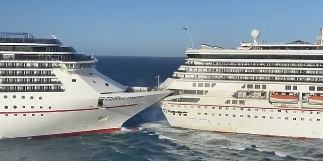 The Carnival Glory cruise ship, right, crashes into the Carnival Legend on Friday morning. The cruise line currently believes the collision was caused by “spontaneous wind gusts and strong currents.”