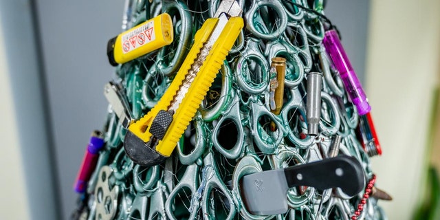 The tree featured knives, scissors, blades, mock guns, bullet cases and lighters, among other dangerous items.