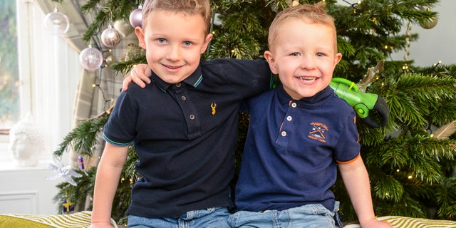 Jacob Scrimshaw, 5, hugging his younger brother Sebastian, 3.