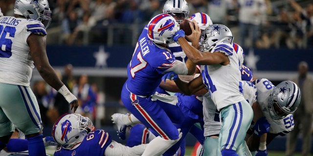 Buffalo Bills quarterback Josh Allen (17) fights for a first down after recovering a fumbled snap as Dallas Cowboys cornerback Byron Jones (31) defends in the first half of an NFL football game in Arlington, Texas, Thursday, Nov. 28, 2019.