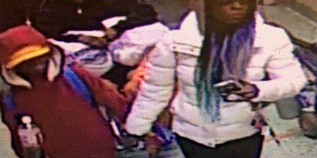 In this image taken from surveillance video released by the Atlanta Police Department, a woman escorts a young man into Grady Memorial Hospital in Atlanta on the night of Dec. 4. Police later identified the woman as Diana Elliott, and arrested her.
