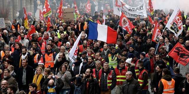 Protestors march in Lille, northern France, on Tuesday. Teachers, doctors, lawyers and workers at the Eiffel Tower were among those who walked off the job to resist a higher retirement age, or to preserve a welfare system they fear their president wants to dismantle.