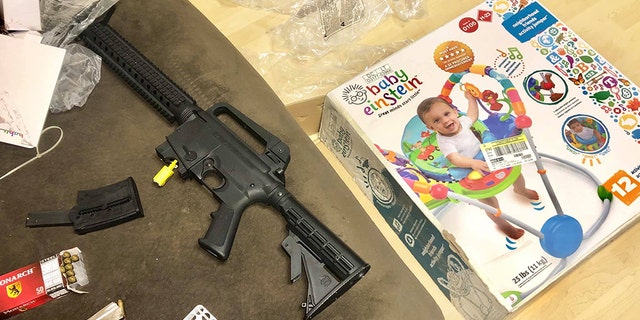 Veronica Alvarez-Rodriguez says this Mossberg 715T semiautomatic rifle was discovered inside a box that was labeled a baby bouncer.
