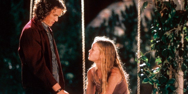 Heath Ledger and Julia Stiles at swing in a scene from the film '10 Things I Hate About You', 1999.