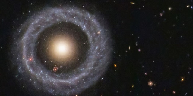 With a perfectly symmetrical ring circling a red sphere of stars, Hoag's object is one of the prettiest mysteries in the universe. (Credit: NASA/ESA/Hubble)