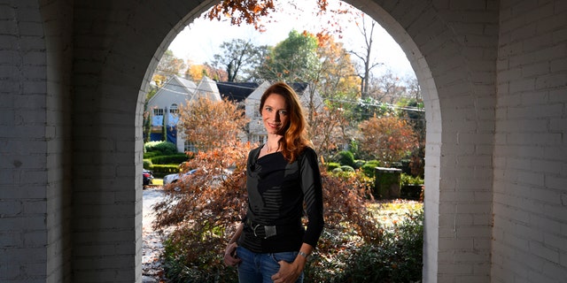 In this Nov. 27, 2019, photo, Georgia Tech professor Kim Cobb poses for a photo at her home in Atlanta. Some climate scientists and activists, including Cobb, are limiting their flying, their consumption of meat and their overall carbon footprints to avoid adding to the global warming they study. (AP Photo/John Amis)