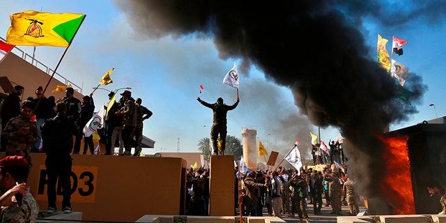 Protesters burn property in front of the U.S. embassy compound. [AP)