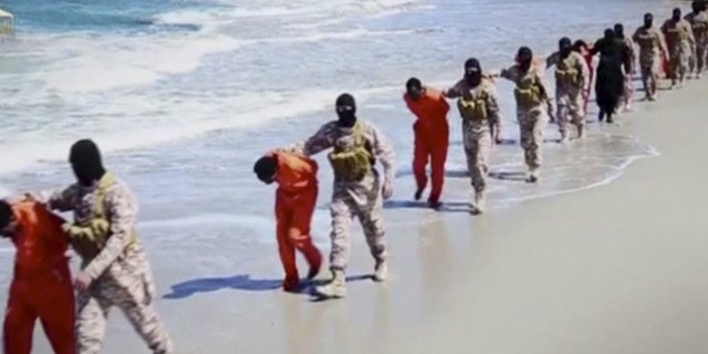 Islamic State militants lead what are said to be Ethiopian Christians along a beach in Wilayat Barqa, in this still image from an undated video made available on a social media website on April 19, 2015. REUTERS/Social Media Website via Reuters