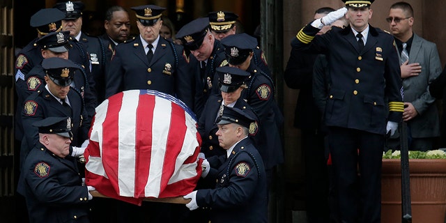 The casket of Jersey City Police Detective Joseph Seals is carried out of the church during his funeral in Jersey City, N.J., on Tuesday. The 40-year-old married father of five was killed in a confrontation a week ago with the Jersey City shooters who then drove to a kosher market and killed three people inside before dying in a lengthy gun battle with police. (AP)