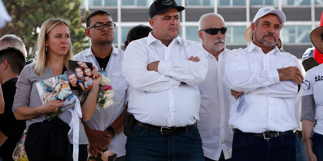 Adriana LeBaron, left, Julian LeBaron, center, and Adrian LeBaron, right, stand during a protest against the first year in office of López Obrador on Monday in Mexico City. The LeBaron's joined a protest to expresse anger and frustration over increasingly appalling incidents of violence, a stagnant economy and deepening political divisions in the country. (AP Photo/Ginnette Riquelme)