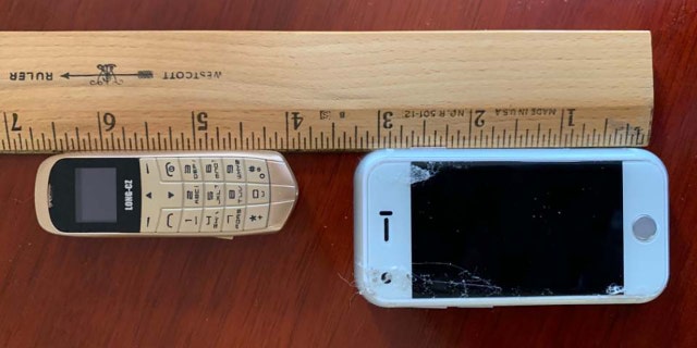 The tiny cellphones discovered hidden underneath the insoles of the shoes all measured about 3 inches long.