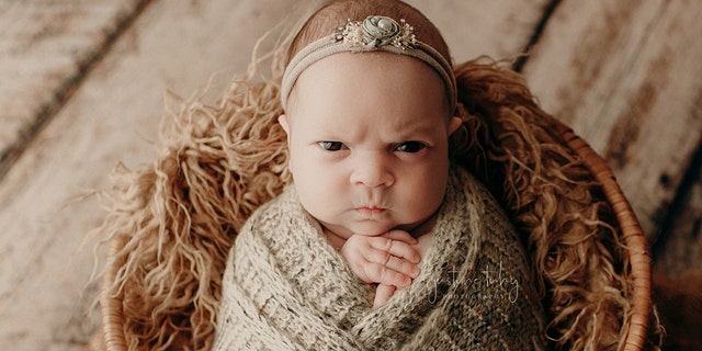 Justine Tuhy, who photographed the session, described the little grump as “the best baby facial expressions I have ever captured!”