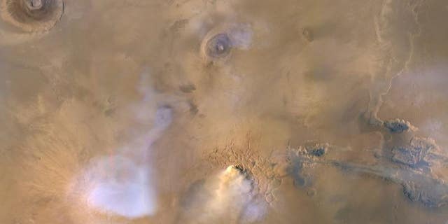 The yellow-white cloud at the bottom center of this image is a "dust tower" on Mars, as seen by NASA's Mars Reconnaissance Orbiter on Nov. 30, 2010.