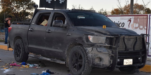 A damaged pick up is on a street of Villa Union, Mexico, after a gun battle between Mexican security forces and suspected cartel gunmen on Saturday.