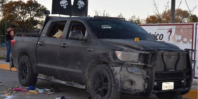 A damaged pick up is on a street of Villa Union, Mexico, after a gun battle between Mexican security forces and suspected cartel gunmen on Saturday.