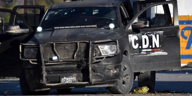 A damaged pick up marked with the initials C.D.N., that in Spanish stand for Cartel of the Northeast, is on the streets after a gun battle between Mexican security forces and suspected cartel gunmen, in Villa Union, Mexico, Saturday, Nov. 30, 2019.