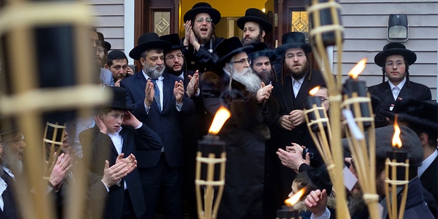 Community members celebrating the arrival of a new Torah at Chaim Rottenberg's home Sunday in Monsey, N.Y. (AP)