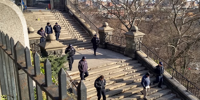 Officers from the New York City Police Department inspect a crime scene where an 18-year-old college student was stabbed to death Wednesday night.