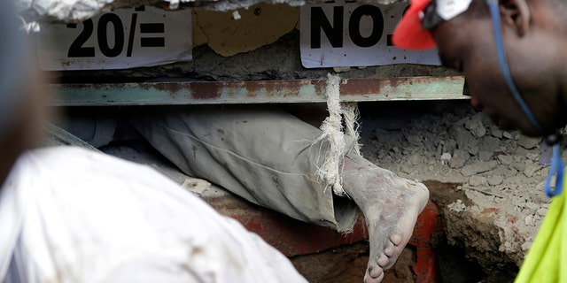 Rescue workers attempt to rescue a person from a collapsed building in Tasia Embakasi, an east neighbourhood of Nairobi, Kenya on Friday Dec. 6, 2019. (Associated Press)