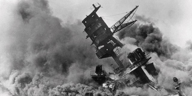 In this Dec. 7, 1941 file photo, smoke rises from battleship USS Arizona as it sinks during Japan's attack on Pearl Harbor, Hawaii. Congress and President Roosevelt enacted daylight saving time amid fears after the surprise attack.  