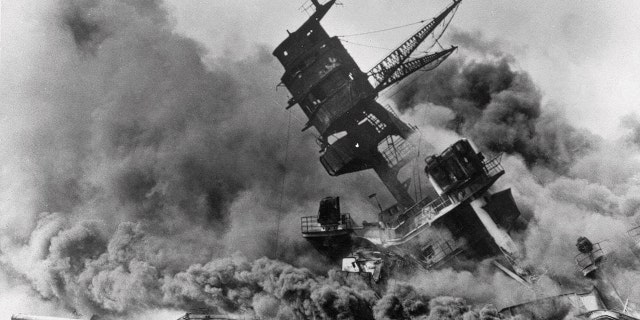 In this Dec. 7, 1941 file photo, smoke rises from the battleship USS Arizona as it sinks during the Japanese attack on Pearl Harbor, Hawaii. 