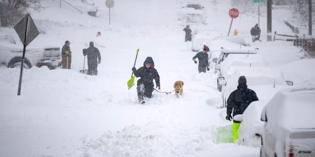 Nor'easter to bury Northeast in snow as deadly storm blamed for pileups, crashes snarl travel 5 Neighbors work together in an effort to clear out as much snow as possible from E. 8th Street, Sunday, Dec. 1, 2019, in Duluth, Minn.