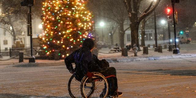 Nor'easter to bury Northeast in snow as deadly storm blamed for pileups, crashes snarl travel 4 Stephen Willard pushes his wheelchair through the snow as he heads to his apartment in Keene, N.H., Sunday, Dec. 1, 2019.