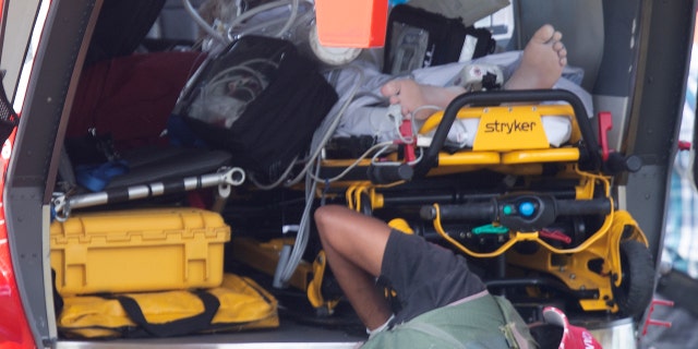 Emergency services attend to an injured person arriving at the Whakatane Airfield after the volcanic eruption Monday, Dec. 9, 2019, on White Island, New Zealand.