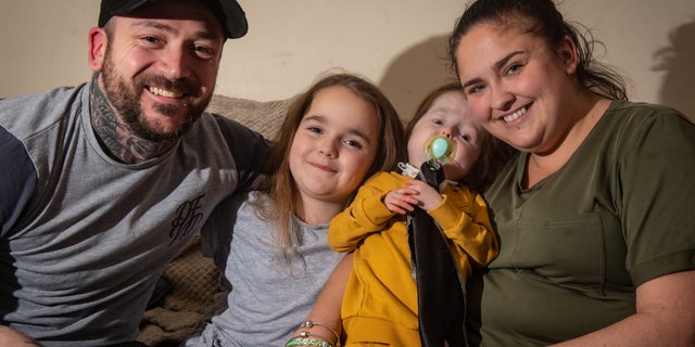 Isla with her parents Stacey and Kyle and sister Paige.