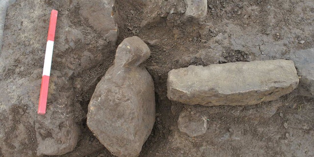 One of the figurines in situ next to the hearth. Finstown. (Credit: ORCA Archaeology)
