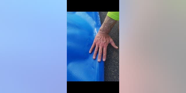 The 57-year-old said the shark bit the back of his board, which immediately caused it to deflate.