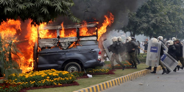 The angry lawyers set police vehicles on fire during the clashes in Lahore. (AP Photo/K.M. Chaudary)