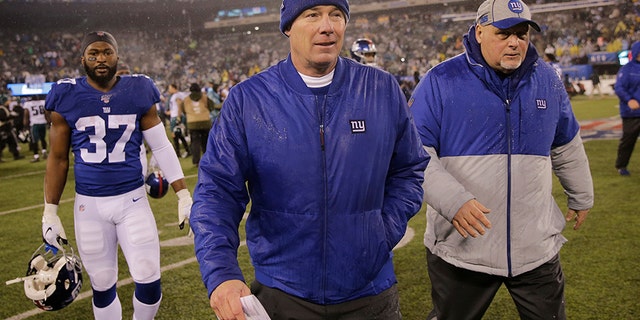 New York Giants head coach Pat Shurmur, center, leaves the field Sunday following the team's defeat to the Philadelphia Eagles. The Giants finished 4-12 on the season.