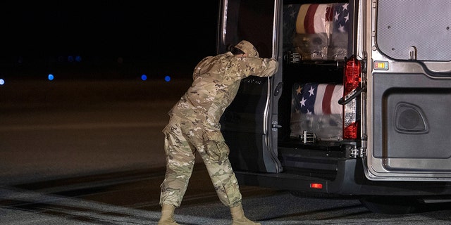 Air Force Door Attendant Staff Sgt. Siannie Conception closes the door of the transfer vehicle carrying the transfer cases containing the remains of Ensign Cameron Joshua Kaleb Watson, Seaman Mohammed Sameh Haitham, and Seaman Apprentice Cameron Scott Walters, Sunday, Dec. 8, 2019, at Dover Air Force Base, Del. A Saudi gunman killed the three people in a shooting at Naval Air Station Pensacola in Florida.