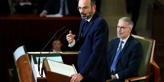 French Prime Minister Edouard Philippe delivers his speech Wednesday, Dec. 11, 2019 in Paris as he unveils proposals on pension reforms. (Thomas Samson/Pool via AP)