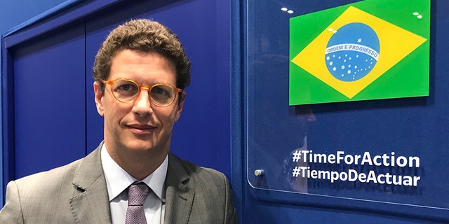In this photo taken on Saturday, Brazilian environment Ricardo Salles stands outside the Brazil delegation room at the COP25 U.N. climate talks in Madrid, Spain.